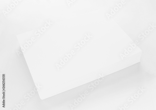 A4 blank paper stack with soft shadows isolated on white background