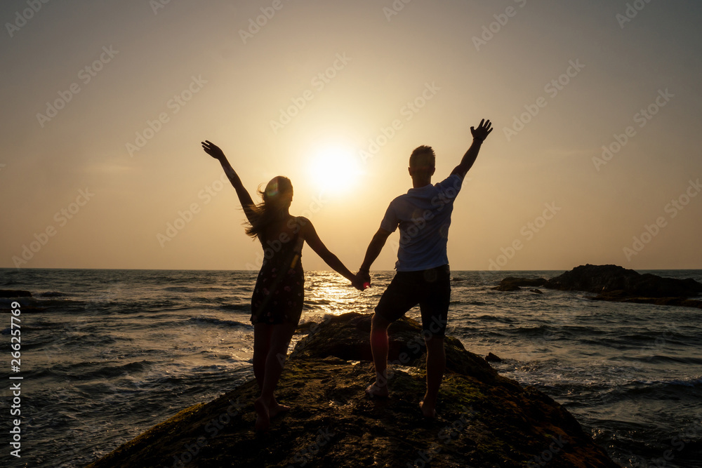 Fototapeta premium Young couple in love on the beach February 14, St. Valentine's Day sunset Goa India vacation trip .travel new year in a tropical country. freedom concept