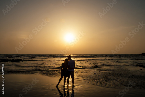 Young couple in love on the beach February 14, St. Valentine's Day sunset Goa India vacation trip .travel new year in a tropical country. freedom concept