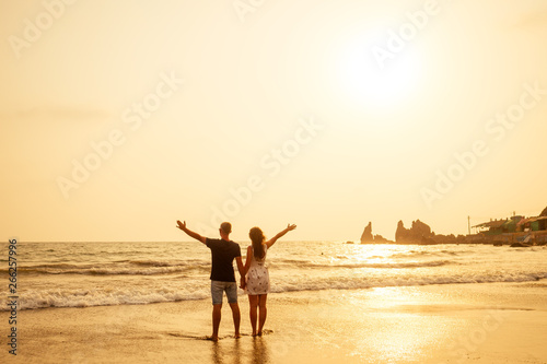 Young couple in love on the beach February 14, St. Valentine's Day sunset Goa India vacation trip .travel new year in a tropical country. freedom concept