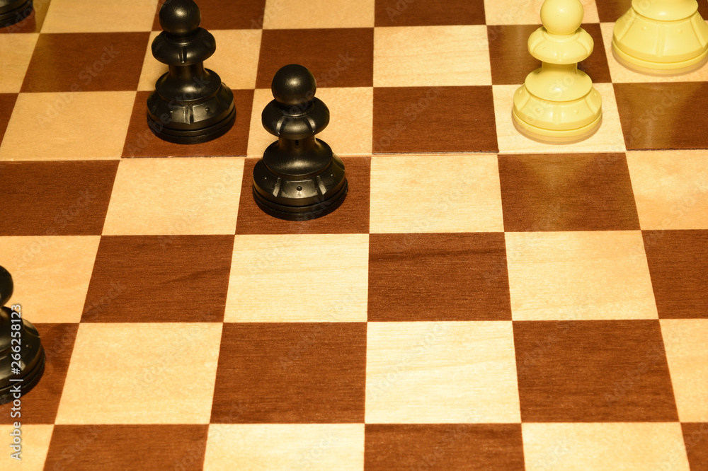 Chechered board under white chessmen like a sport backdrop Chechered board under white chessmen like a sport backdrop