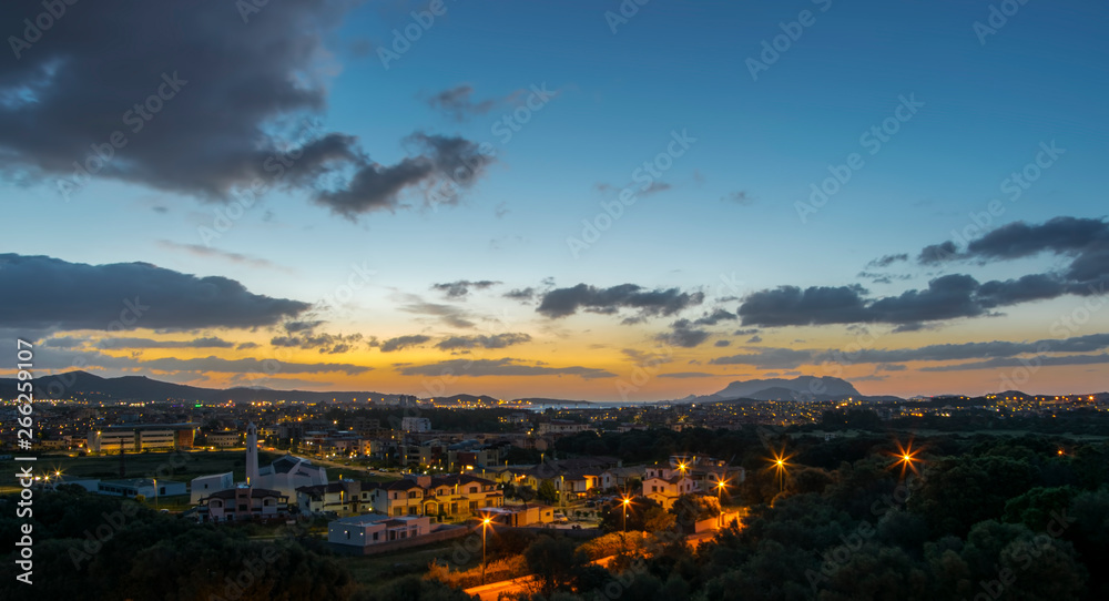 Vista panoramica di Olbia all'alba, sullo sfondo l'isola di Tavolara e il Porto, in basso a sinistra la Parrocchia di San Michele Arcangelo, Sardegna	