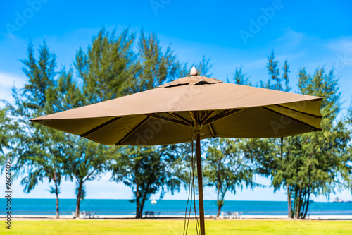 Umbrella and chair on the green grass nearly sea beach