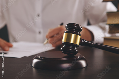 Close up view of wooden gavel. Male attorney working with paper documents