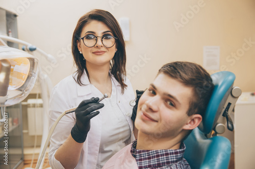Taking oral care. Dentist and male patient in the dental room