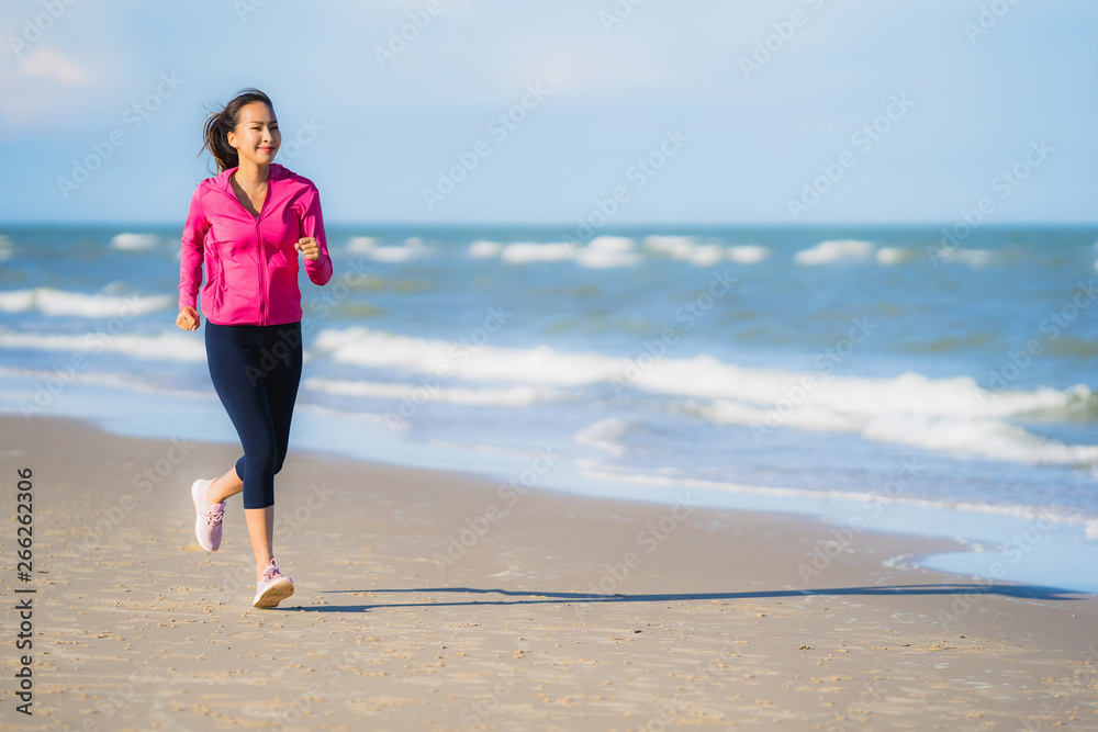 Portrait beautiful young asian woman running or exercise on the tropica nature landscape of beach Portrait beautiful young asian woman running or exercise on the tropica nature landscape of beach