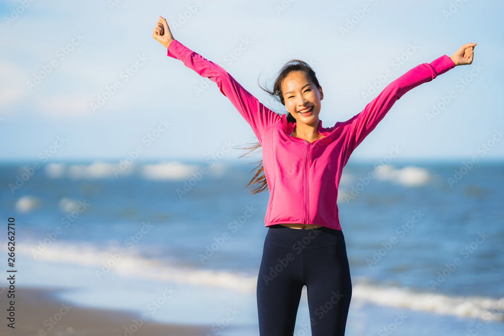 Portrait beautiful young asian woman running or exercise on the tropica nature landscape of beach Portrait beautiful young asian woman running or exercise on the tropica nature landscape of beach