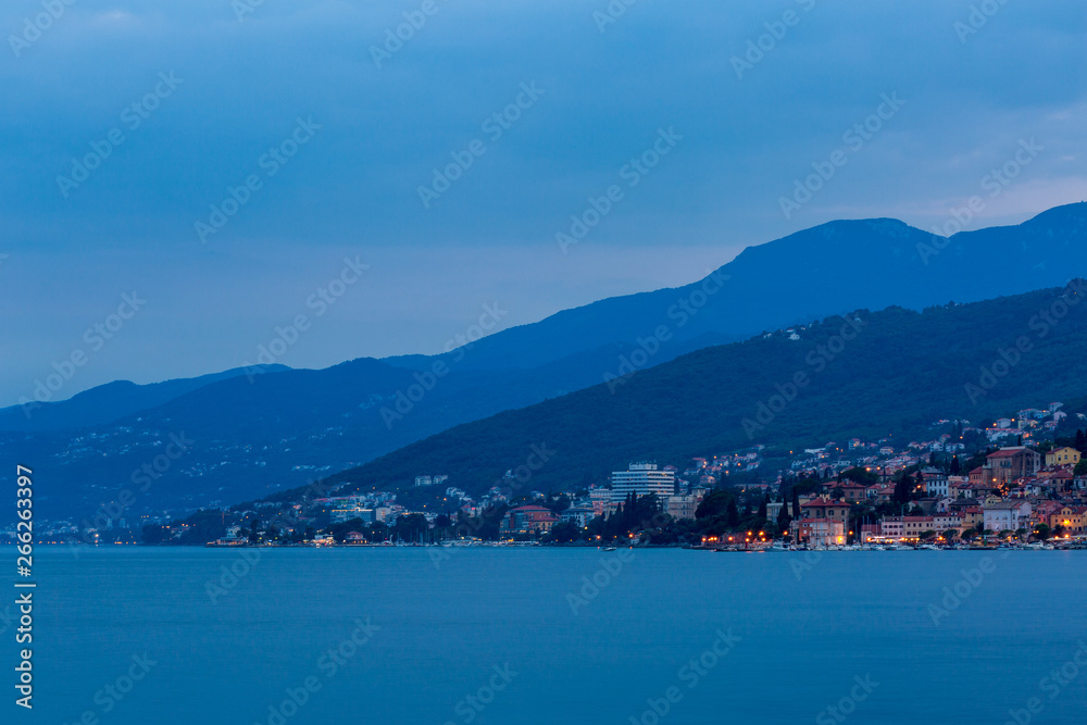 Blue evening on the sea, view to the town