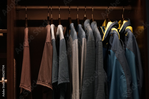 Clothes hanging in the closet on hangers, the concept of shopping or sales