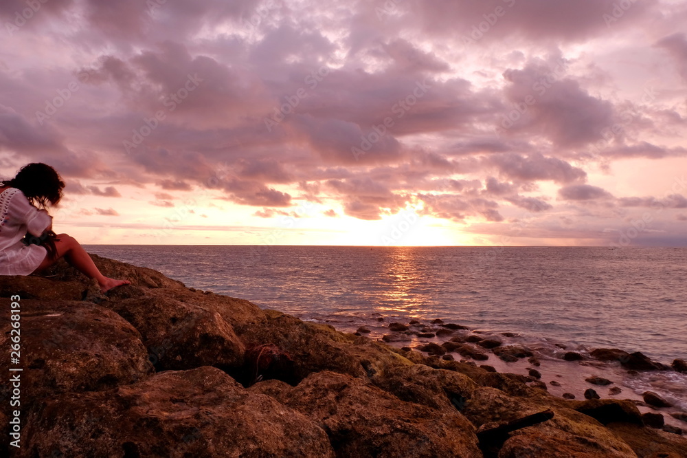 the beauty of panati Kuta Bali at dusk, with stunning orange and gold colors