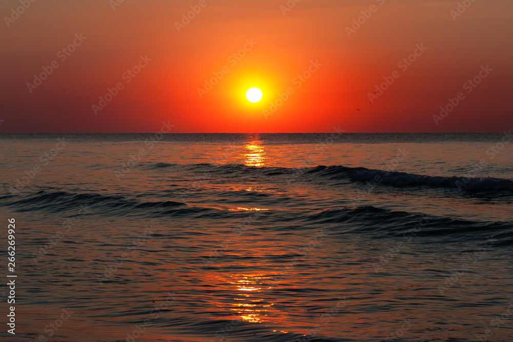 Beautiful sunrise over the quiet calm sea.