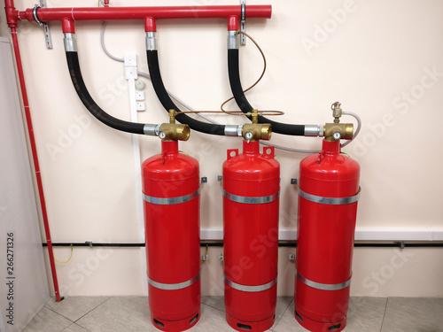 Automatic fire extinguishing system in the workplace. The security of your premises from conflagration. Red cylinders with compressed gas to prevent fire in the shop.