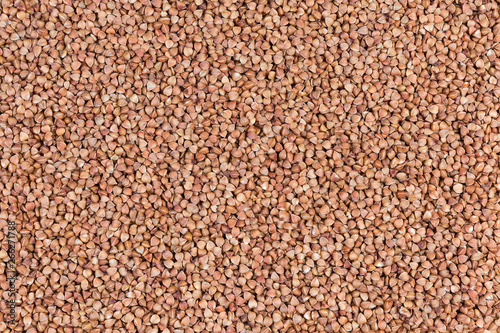 Background of uncooked pre-steamed buckwheat groats