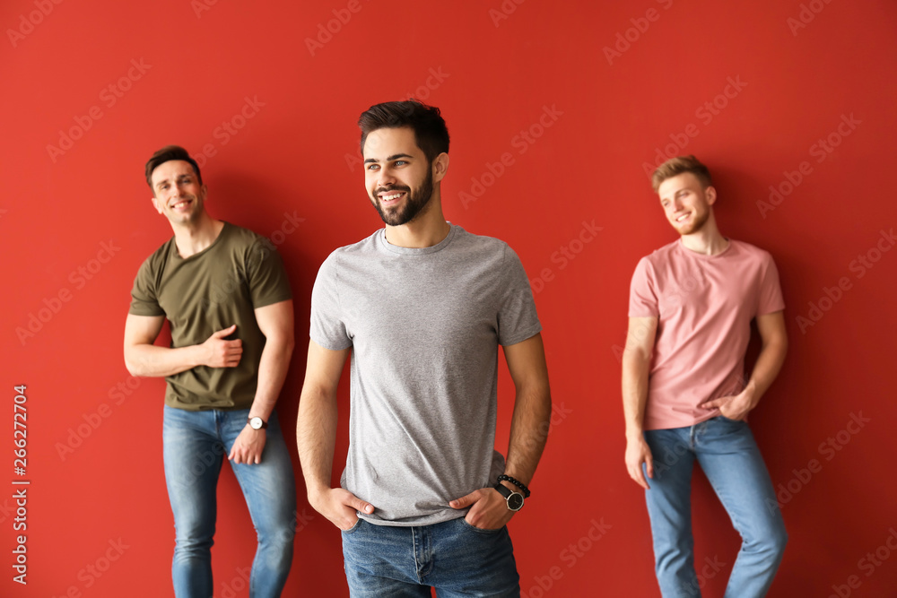 Fashionable young men on color background Fashionable young men on color background