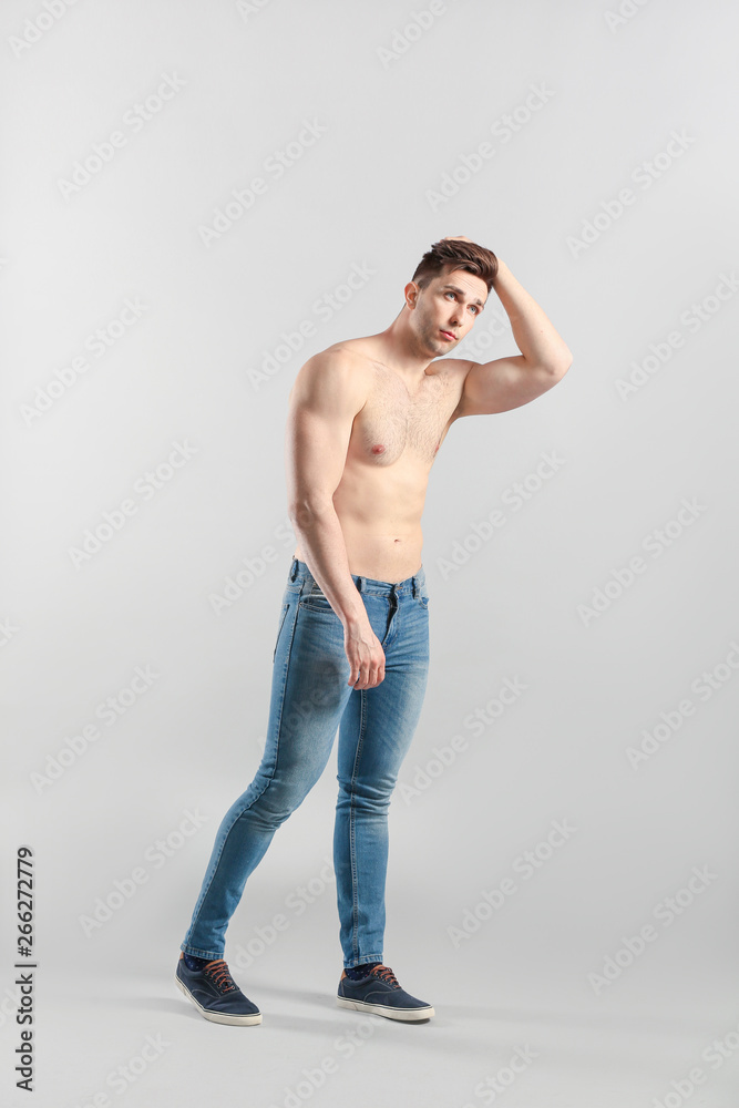 Sporty young man on grey background