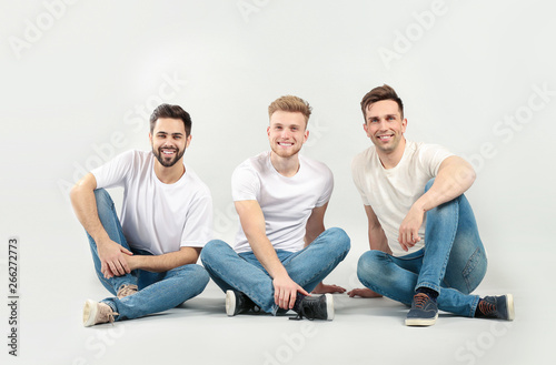 Handsome young men on light...