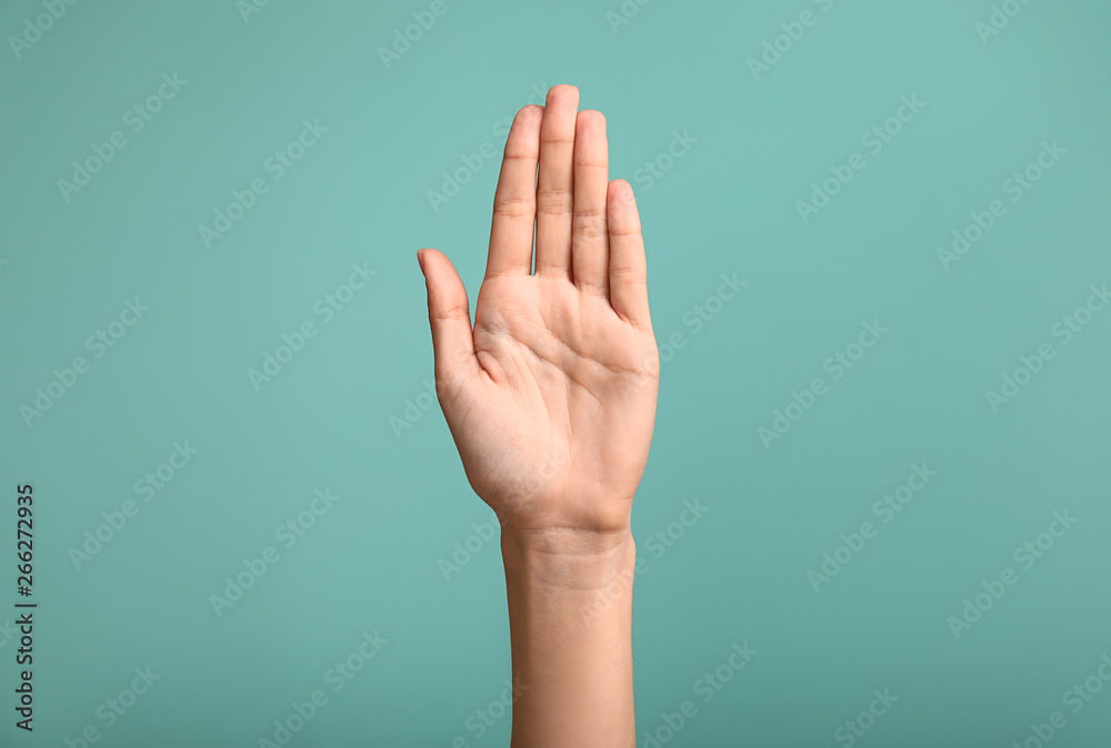 Gesturing female hand on color background - obrazy, fototapety, plakaty 