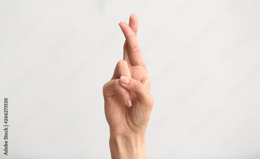 Female hand showing letter R on light background Female hand showing letter R on light background