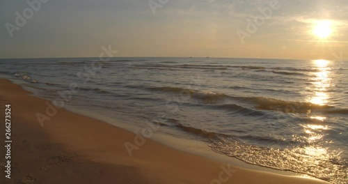 Wallpaper Mural Static slow motion shot of waves gently rolling up onto the beach in late afternoon with sun off to right. Torontodigital.ca