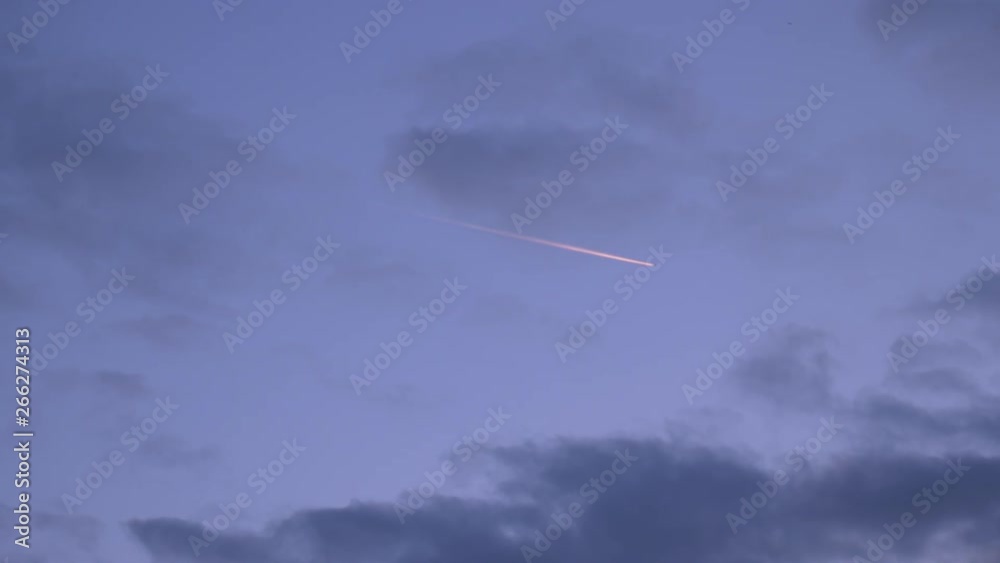 Time Lapse Airplane Contrail Across Evening Sky. Time Lapse Airplane Contrail Across Evening Sky.