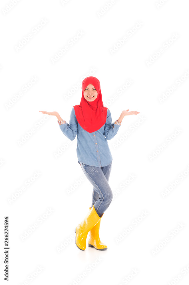 Young muslimah wearing yellow boot in pose