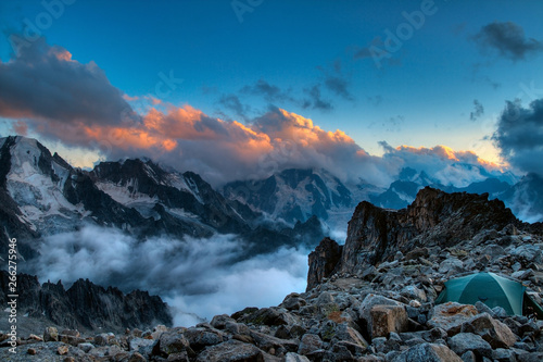 Fantastic morning landscape of rocky mountains at sunrise. Dramatic clouds in burning sky  morning light.