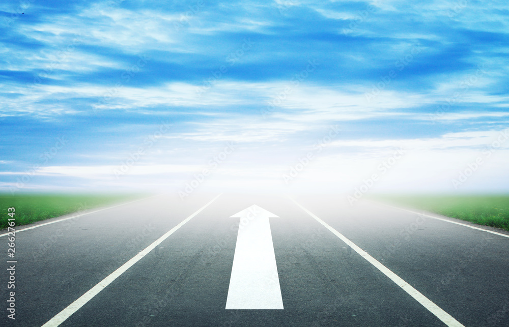 Fototapeta premium Background of blurred asphalt road, clear blue sky with clouds. Sunlit skyline