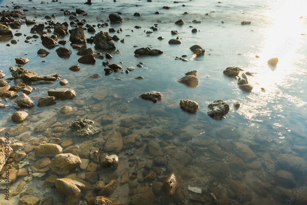 Waves on stone beach waters edge abstract sea background.Thailand. Waves on stone beach waters edge abstract sea background.Thailand.