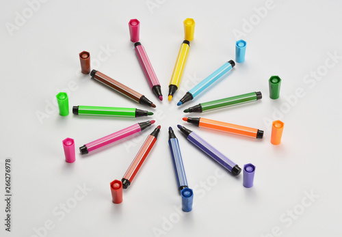 Multi colored felt tip pens on white background