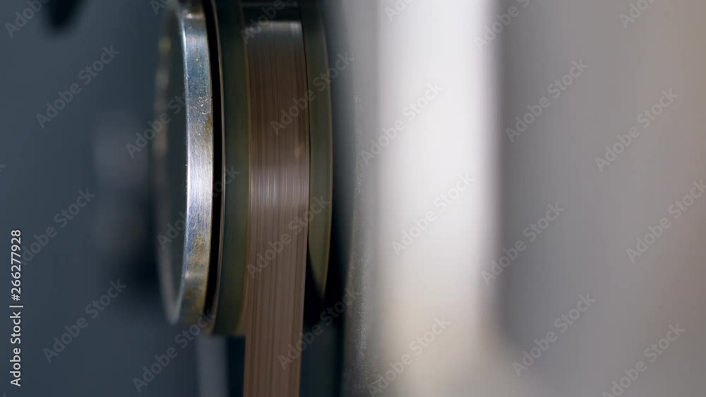 Tape rolling on a reel recorder.