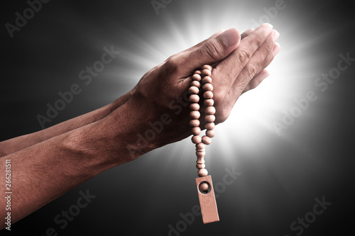 Hands of muslim man praying with rosary beads