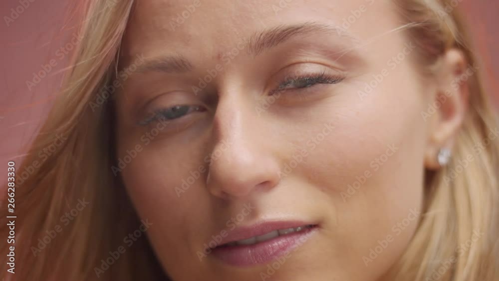 closeup blond woman with green eyes and she is slightly smiling closeup blond woman with green eyes and she is slightly smiling