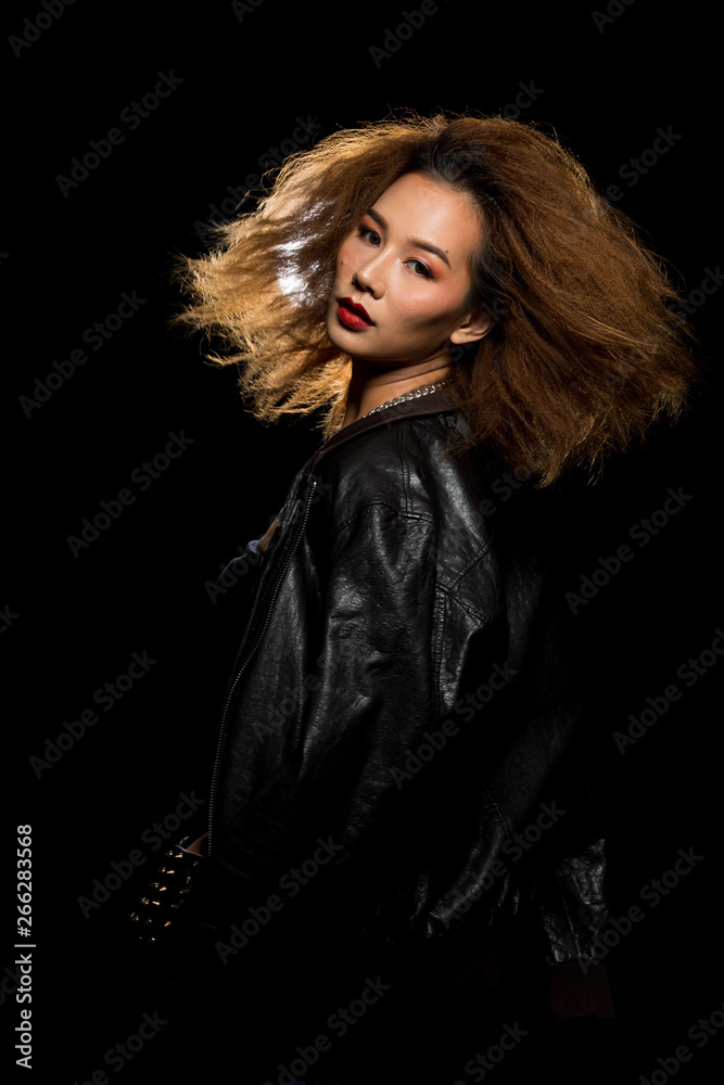 Fashion Asian Woman Tan skin Afro fu hair eyes beautiful make up black bra jacket silver necklace posing, Studio Lighting Dark Background back rim light with steam smoke effect