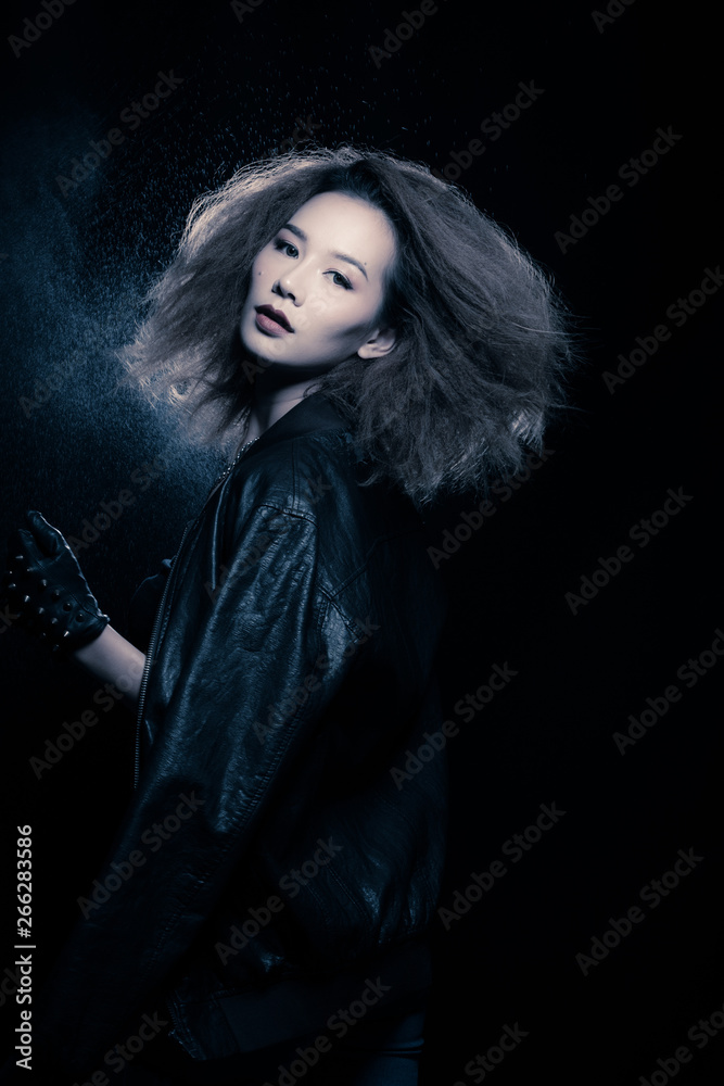 Fashion Asian Woman Tan skin Afro fu hair eyes beautiful make up black bra jacket silver necklace posing, Studio Lighting Dark Background back rim light with steam smoke effect