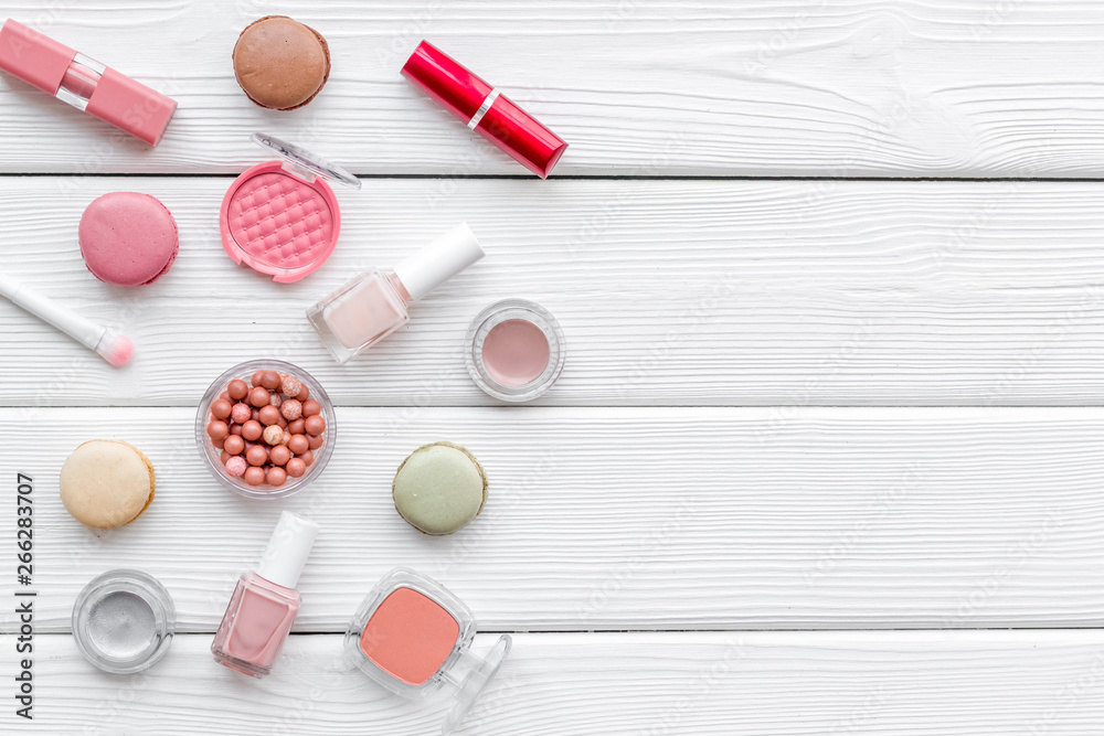 make-up accessories, fashion stylish cosmetics and macaroon on white wooden desk background top view copy space make-up accessories, fashion stylish cosmetics and macaroon on white wooden desk background top view copy space