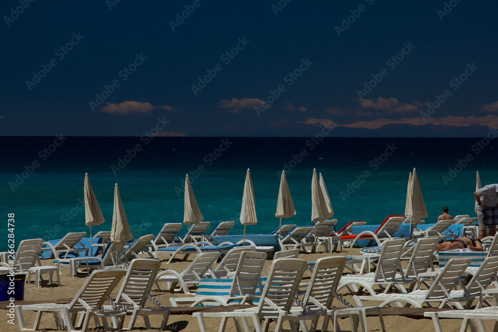 azure sea and beautiful beach with sun beds
