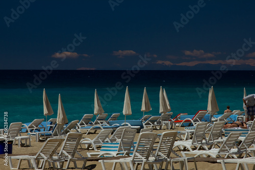 azure sea and beautiful beach with sun beds