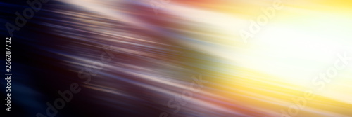 Abstract blurred background diagonal light lines on a dark multi-colored background and a bright yellow spot.