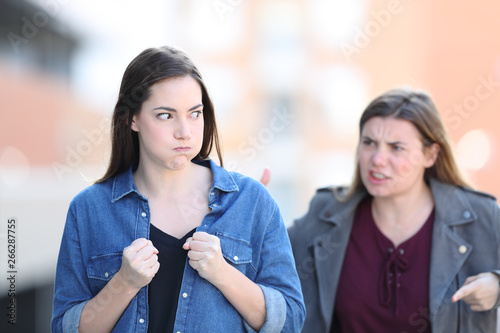Two angry friends arguing in the street