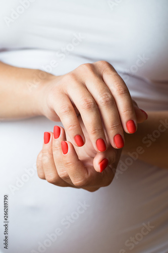 Closeup photo of a beautiful female hands with red nails © olllinka2