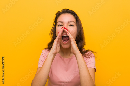 Young european woman isolated over yellow background shouting excited to front.
