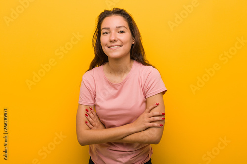 Young european woman isolated over yellow background laughing and having fun.