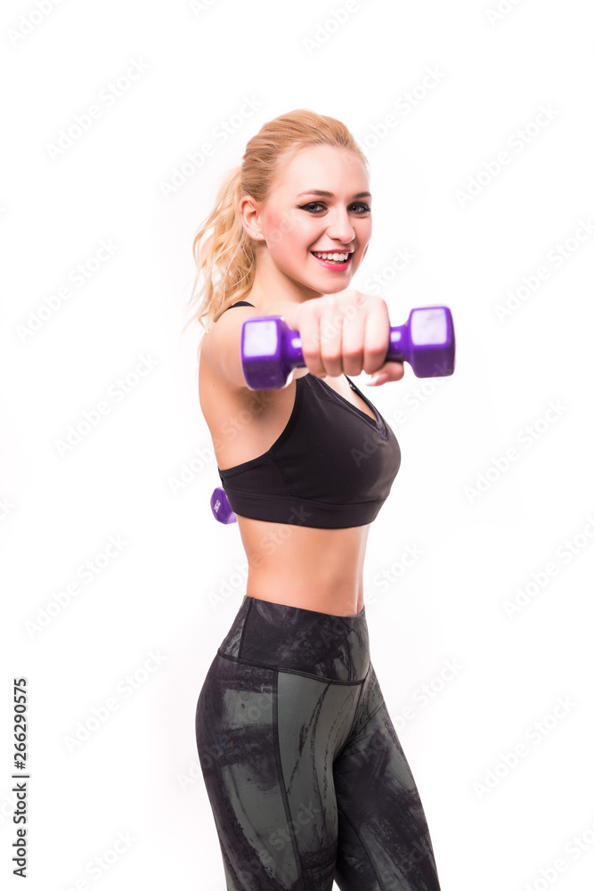 Young happy smiling blond woman in sportswear, doing fitness exercise with dumbbells against white background Young happy smiling blond woman in sportswear, doing fitness exercise with dumbbells against white background