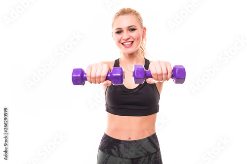 Torso of a young fit woman lifting dumbbells on white background