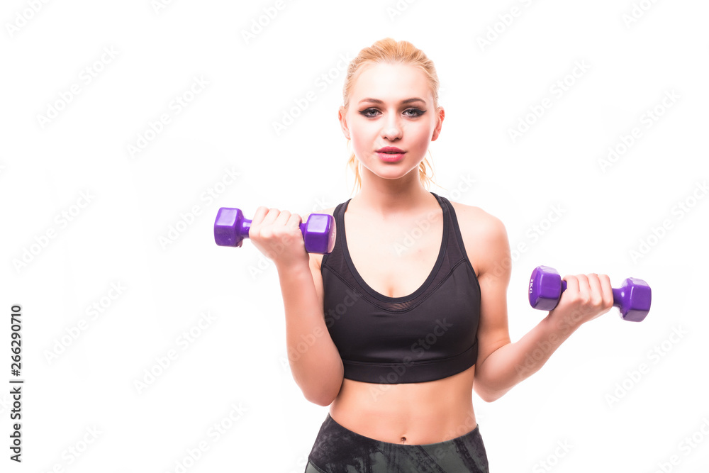 Young happy smiling blond woman in sportswear, doing fitness exercise with dumbbells against white background Young happy smiling blond woman in sportswear, doing fitness exercise with dumbbells against white background