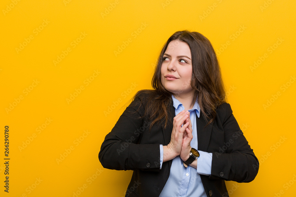 Young plus size caucasian business woman making up plan in mind, setting up an idea. Young plus size caucasian business woman making up plan in mind, setting up an idea.