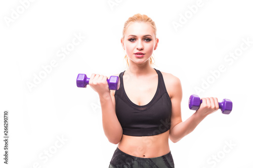 Young happy smiling blond woman in sportswear, doing fitness exercise with dumbbells against white background