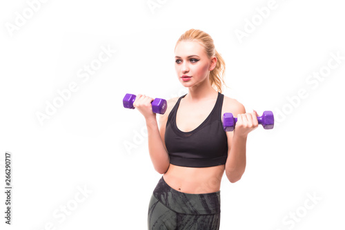 Feeling awesome. Portrait of a beautiful and sporty young woman lifting up weights against white background.