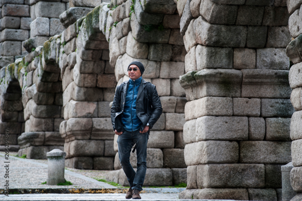 Tourist walking to Roman aqueduct in Segovia the historic city Romanesque architecture locate at northwest of Madrid, Spain. Tourist walking to Roman aqueduct in Segovia the historic city Romanesque architecture locate at northwest of Madrid, Spain.