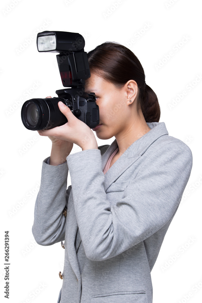 Asian Woman Photographer hold camera with external flash point to shoot subject, wear formal black suit. studio lighting white background isolated copy space, reporter journalist take photo celebrity